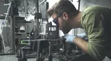researcher with optical setup researcher with optical setup